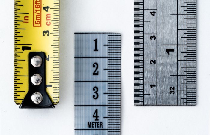 High-resolution image of a tape measure and rulers, showing precise millimeter, centimeter, and inch markings.