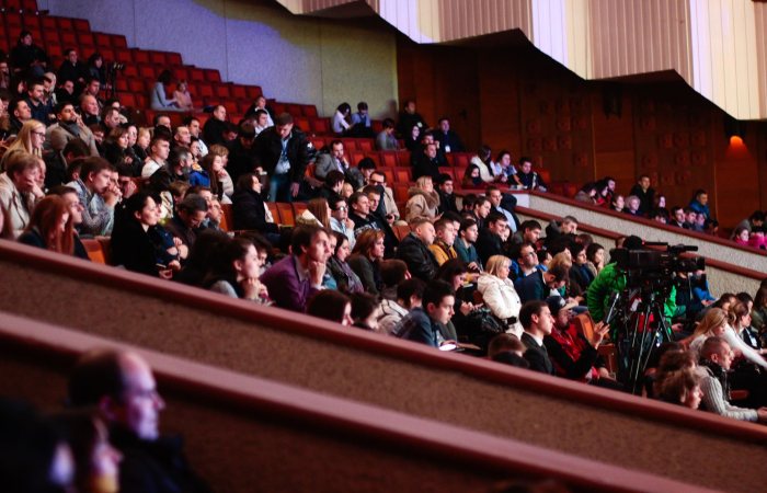 Engaged audience seated indoors, captured with a Canon camera. Ideal for event coverage visuals.