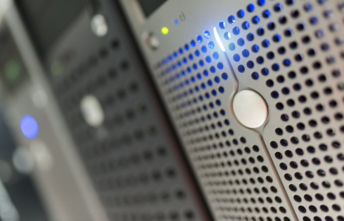 Focused detail of a modern server rack with blue LED indicators in a data center.