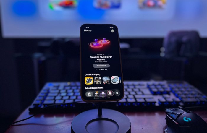 A stylish gaming setup featuring a smartphone on a stand with a vibrant display, keyboard, and mouse.