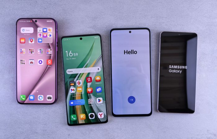 Four modern smartphones showcasing home screens, applications, and startup logos on a sleek surface.